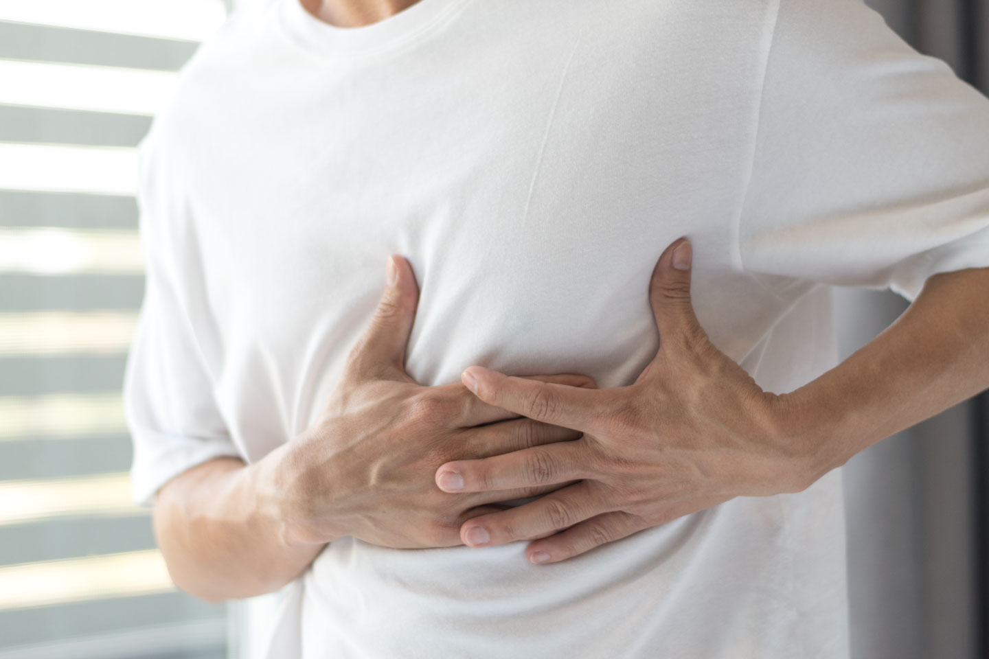 man holding his ribs in pain